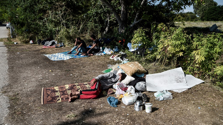 Yazidi migrants from Iraq sleep as they wait for the entry into a refugee camp in Serres, northern Greece, as they have been stranded outside the camps in Serres for nearly 2 weeks,  Sept. 6, 2022. (Photo: Sakis Mitrolidis/AFP)