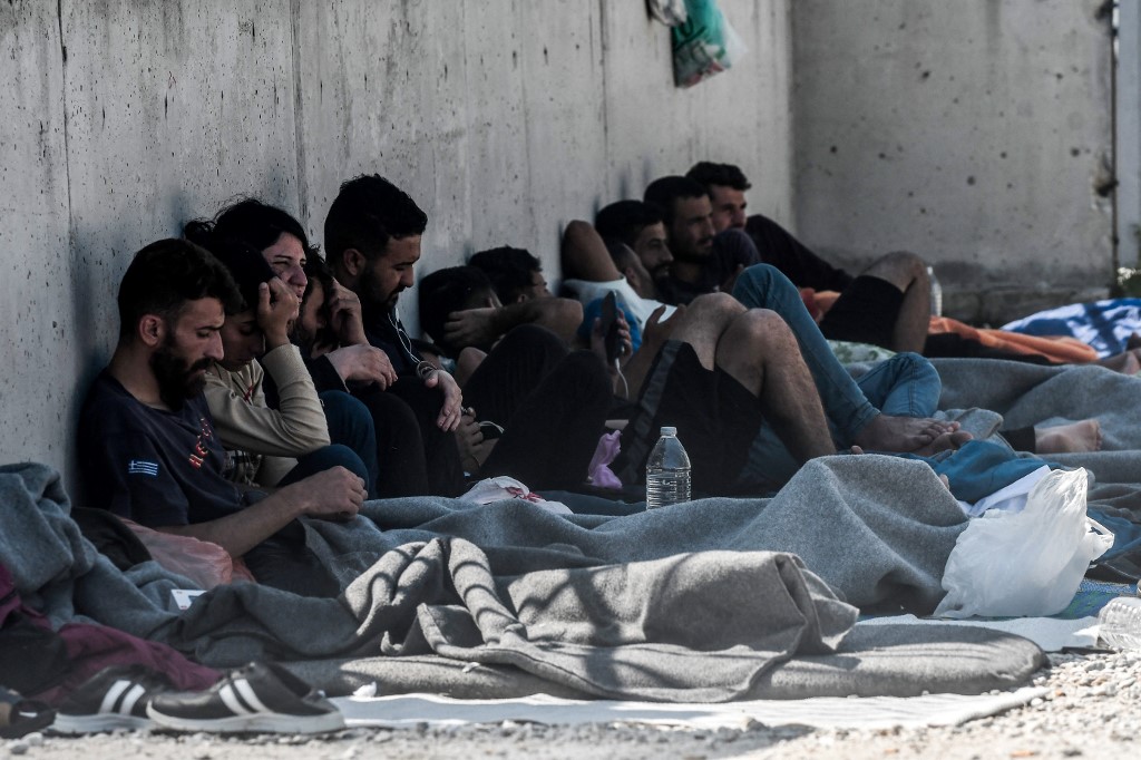 Yazidi migrants from Iraq wait for the entry into a refugee camp in Serres, northern Greece, as they have been stranded outside the camps in Serres for nearly 2 weeks, on Sept. 6, 2022. (Photo: Sakis Mitrolidis/AFP)