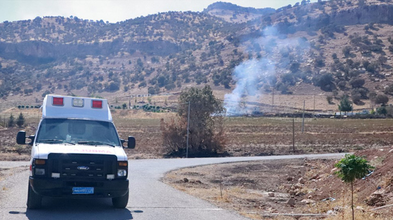 Smoke billows as an ambulance drives in the area of Zargwez, 15 kms outside the Iraqi city of Sulaimaniyah, where several exiled left-wing Iranian Kurdish parties maintain offices, Sept. 28, 2022. (Photo: Shwan Mohammed/AFP)