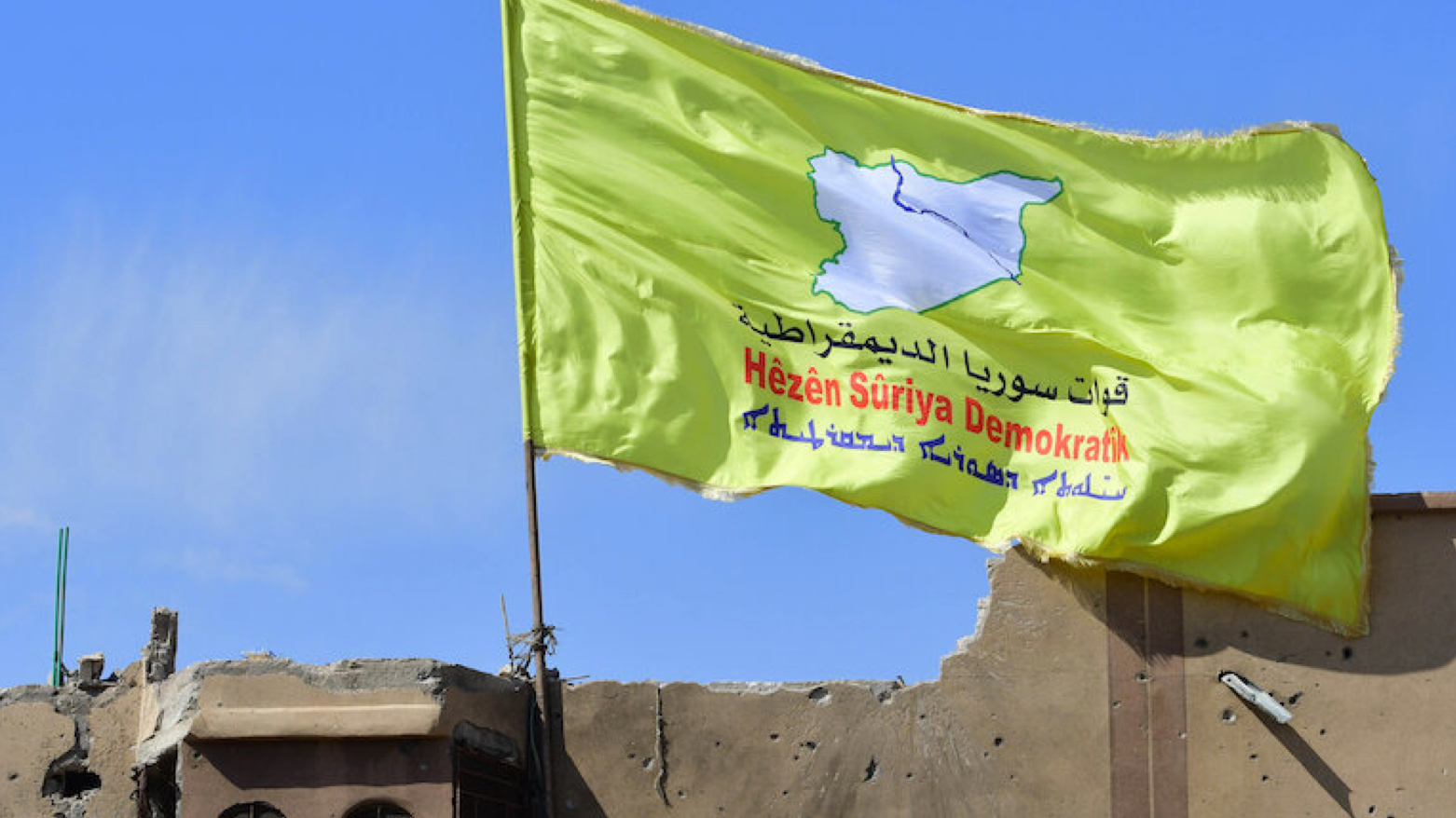 A banner of the Syrian Democratic Forces (SDF) is flown in northeastern Syria (Photo: Giuseppe Cacace/AFP)