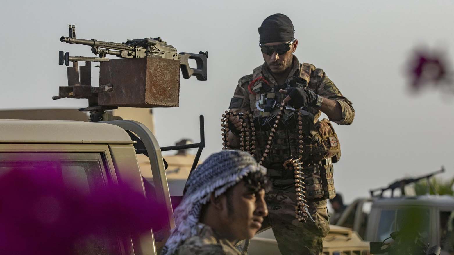 Fighters of the Syrian Democratic Forces (SDF) stands guard along a road as others deploy to impose a curfew in the town of al-Busayrah in Syria's northeastern Deir ez-Zor province on September 4, 2023 (Photo: Delil Souleman/AFP)