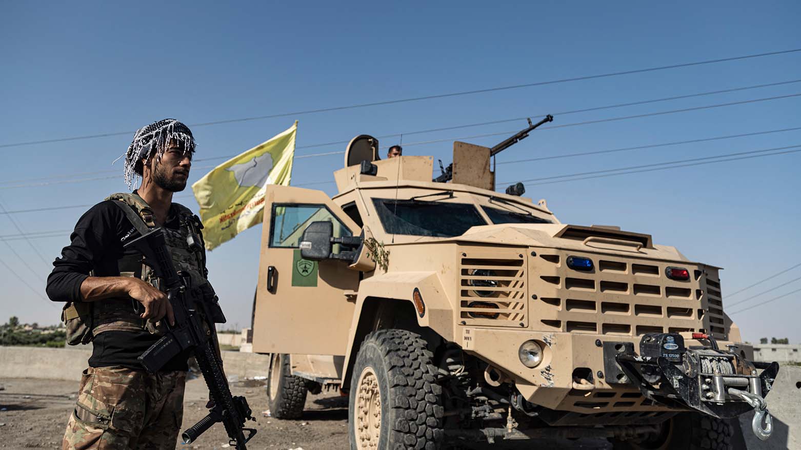 A U.S.-backed Syrian Democratic Forces (SDF) fighter stands next an armored vehicle, at al-Sabha town in the eastern countryside of Deir el-Zour, Syria, Sept. 4, 2023. (Photo: Baderkhan Ahmad/ AP)
