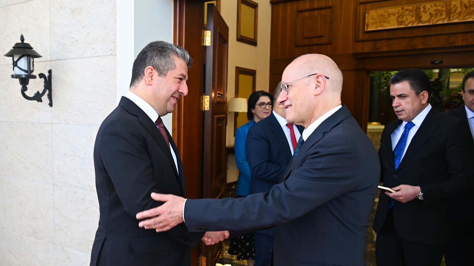 Kurdistan Region Prime Minister Masrour Barzani (left) shaking hands with Emberti Gialloreti Leonardo of the Community of Sant'Egidio in Erbil, Sept. 17, 2023. (Photo: KRG)