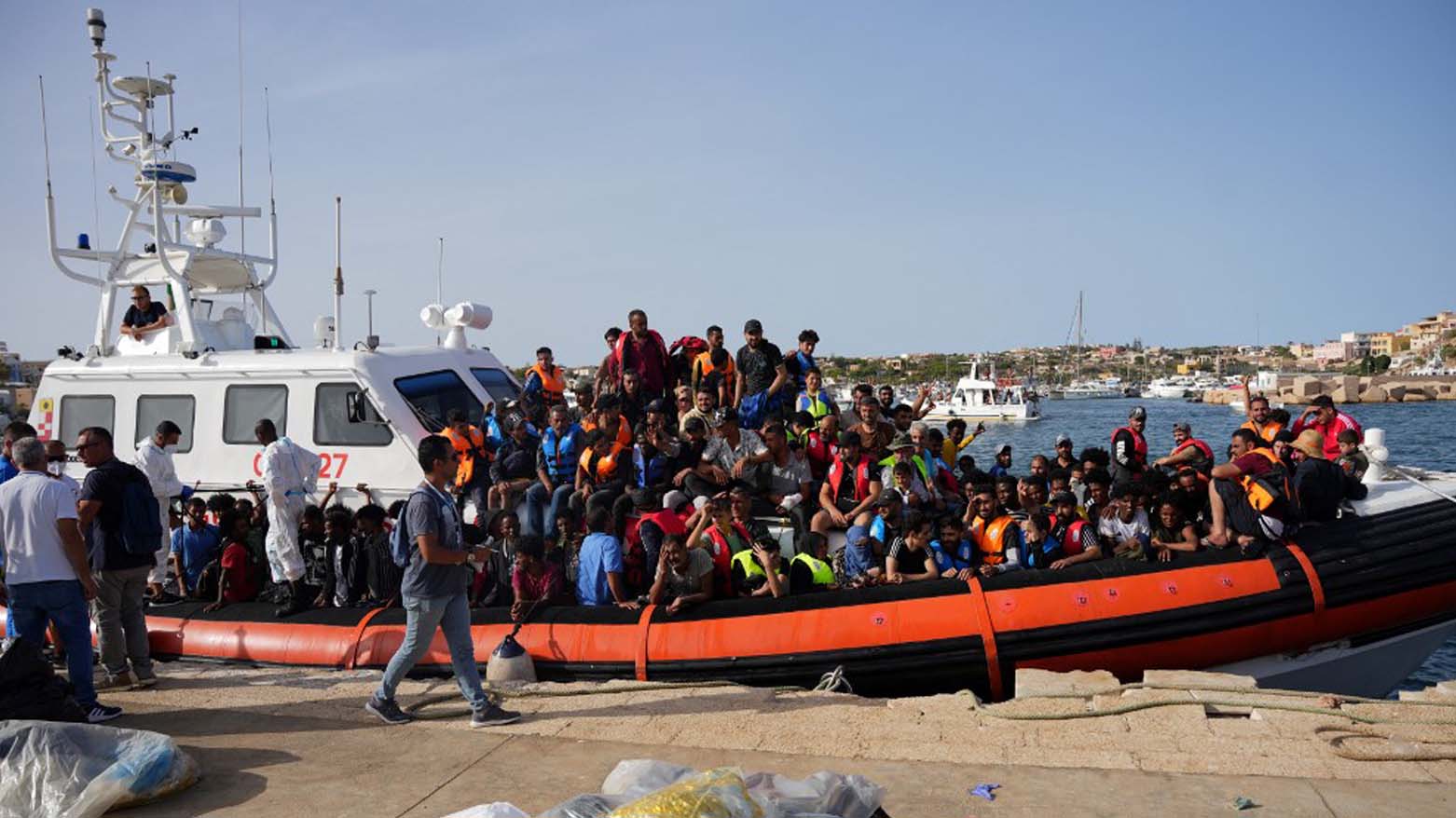 Migrants arrive in the harbour of Italian island of Lampedusa, on September 18, 2023. (Photo: Zakaria Abdelkafi/AFP)