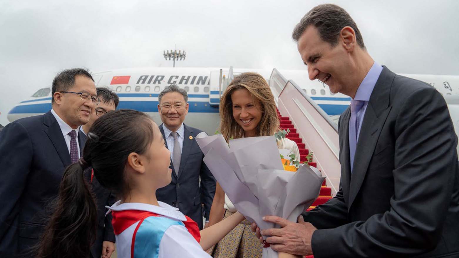 Syria's President Bashar al-Assad (R) and First Lady Asma al-Assad (2-R) being welcomed upon their arrival at the airport in Beijing, September 21, 2023. (Photo: Sana/AFP)