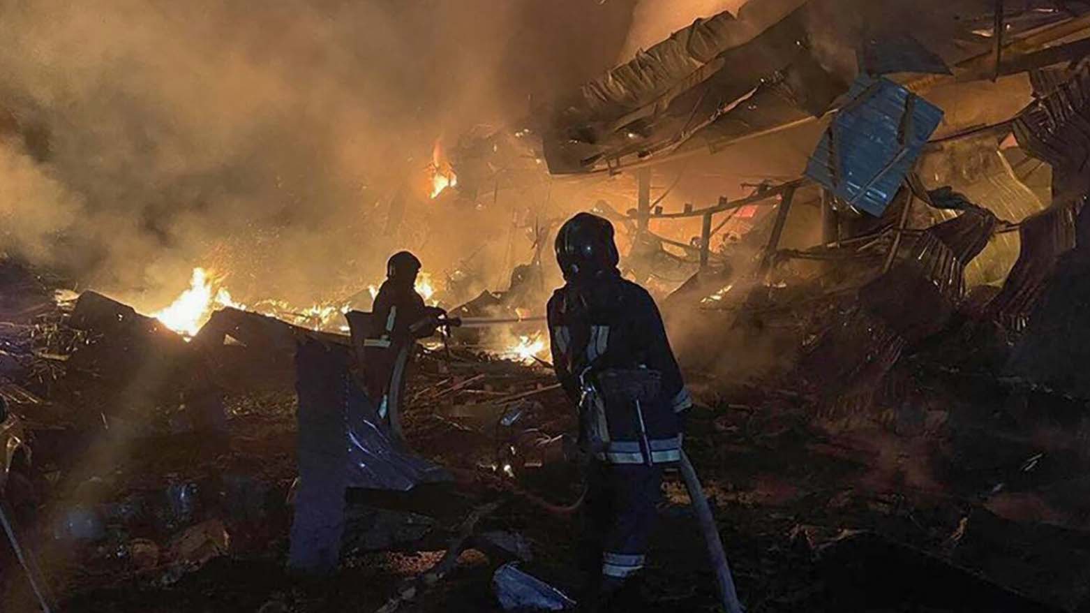 This handout photograph taken and released by Ukrainian Emergency Service on August 14, 2023, shows rescuers pushing out a fire in a supermarket after a night strike in Odesa on Aug. 14, 2023. (Photo: Handout/Ukrainian Emergency Service/AFP
