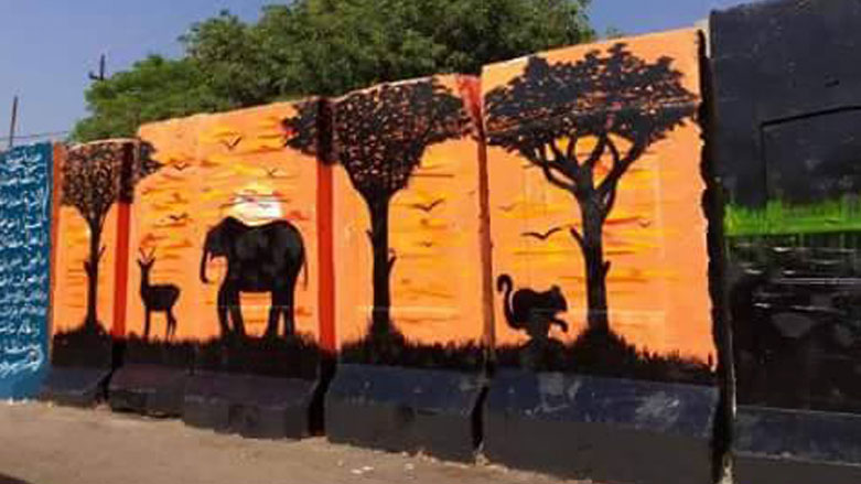 بالصور.. عراقيون يحولون الكتل الخرسانية الى لوحات فنية