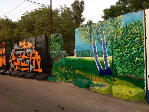 بالصور.. عراقيون يحولون الكتل الخرسانية الى لوحات فنية