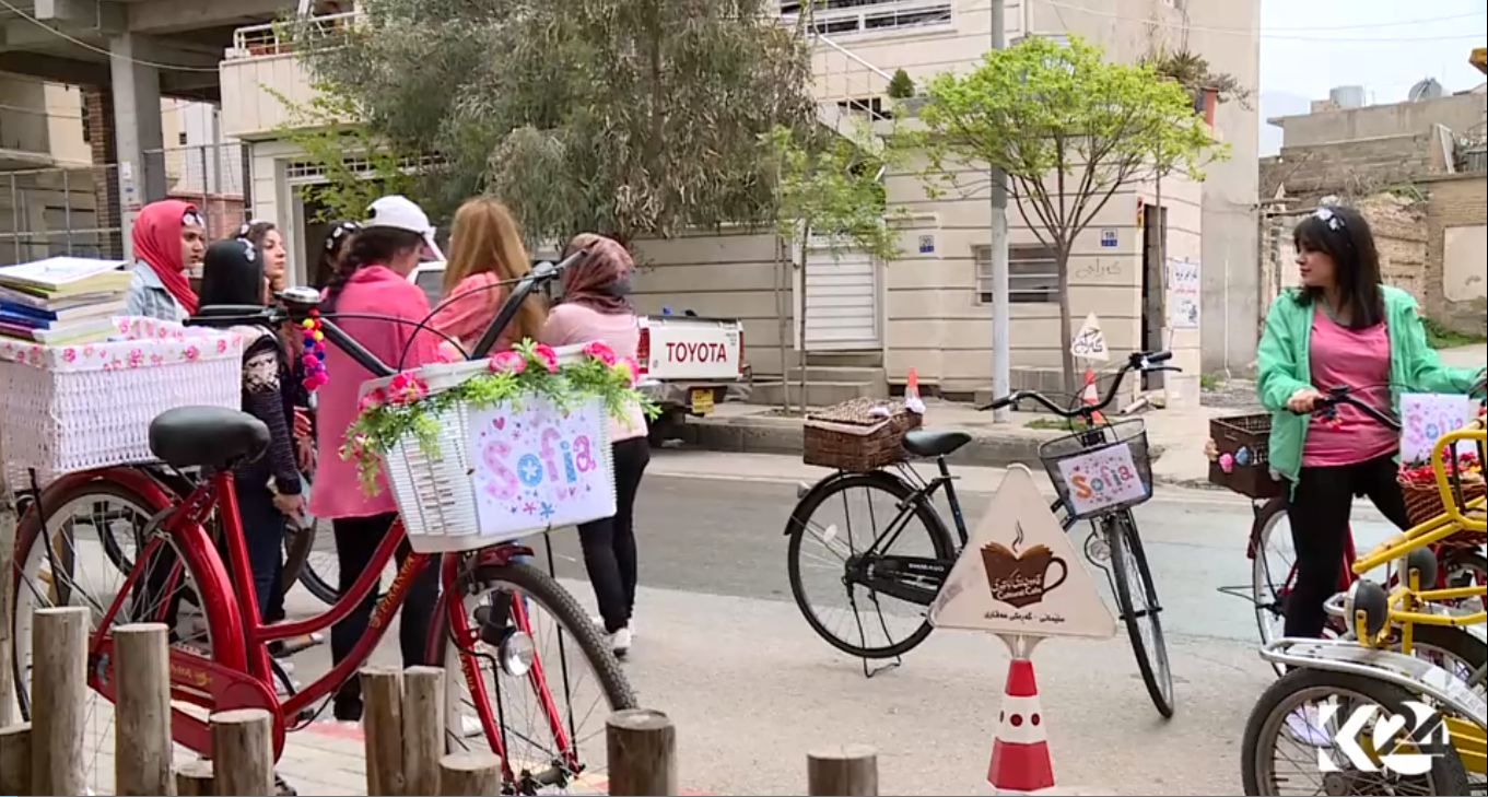 Kurdish women voluntarily deliver books on bikes