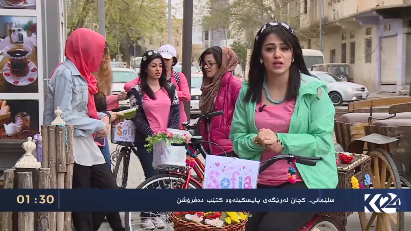Kurdish women voluntarily deliver books on bikes