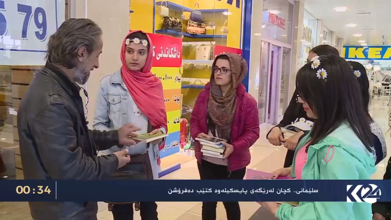 Kurdish women voluntarily deliver books on bikes