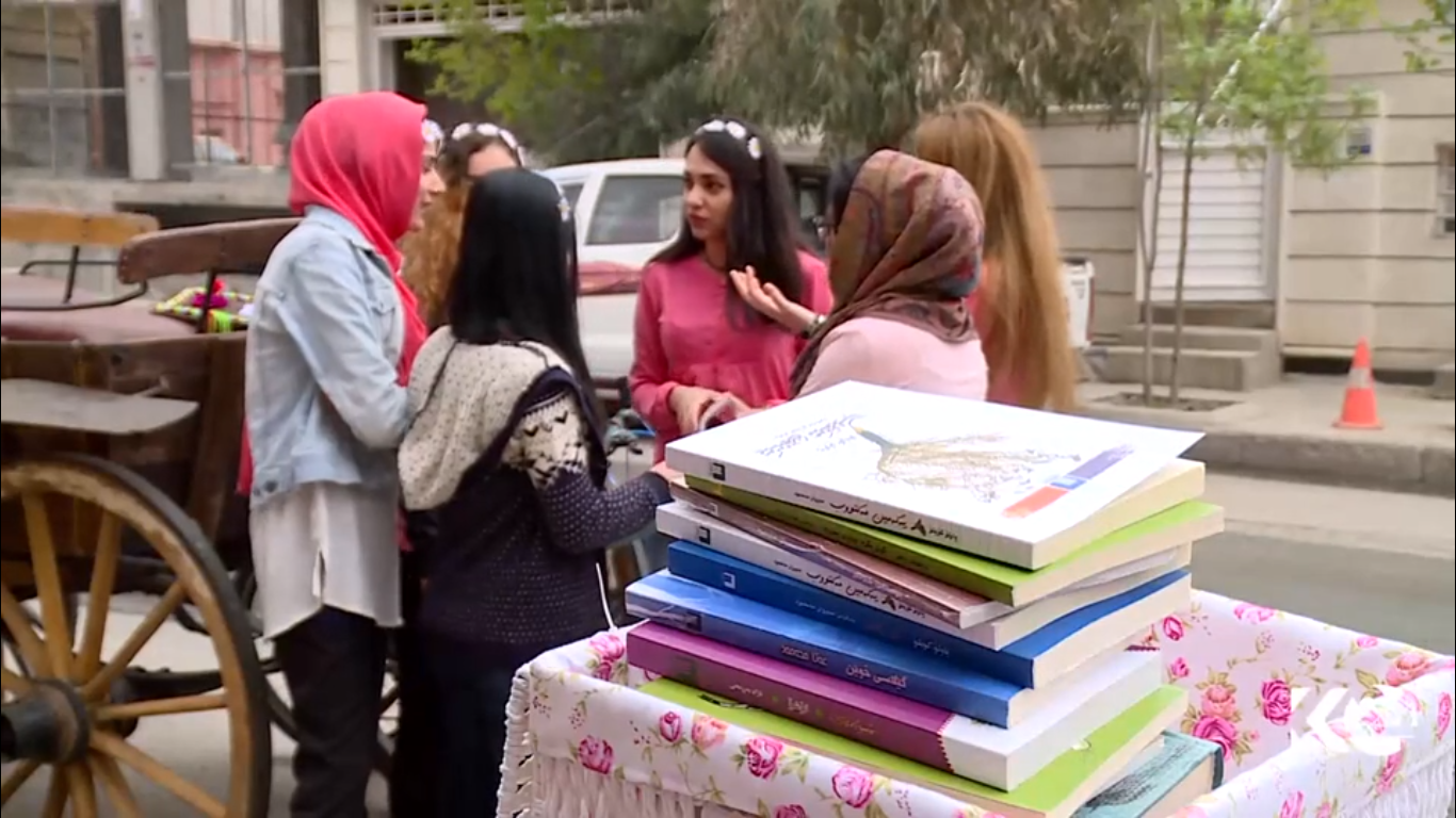 Kurdish women voluntarily deliver books on bikes