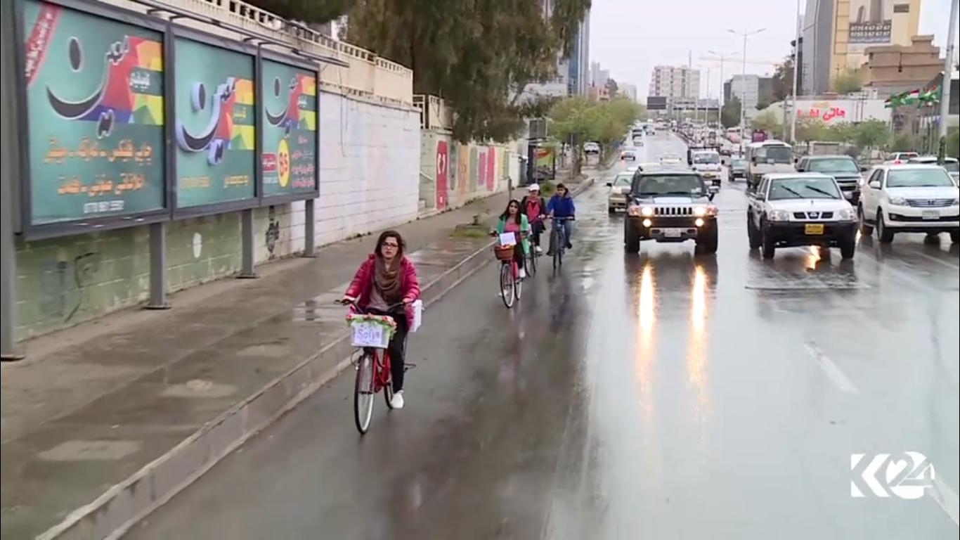 Kurdish women voluntarily deliver books on bikes