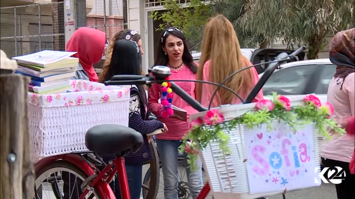 Kurdish women voluntarily deliver books on bikes