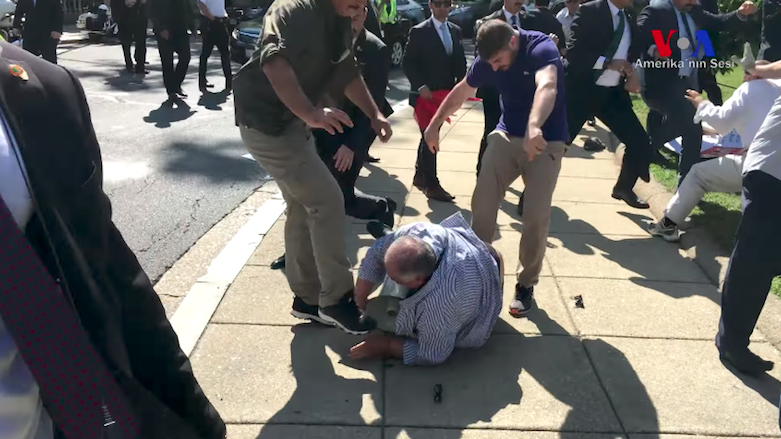 Two members of Erdogan's security detail seen kicking a man lying on the ground as DC police try to engage with other assailants, Washington DC, May 16, 2017. (Source: VOA)