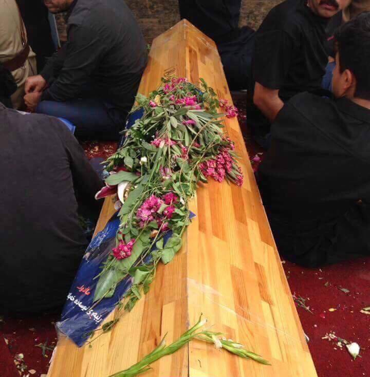 Gorran supporters sitting beside Nawshirwan Mustafa's coffin at Ahmed Haji Ali mosque in Sulaimani. 