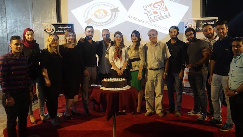 Audience and staff of Media Academy pose for a photograph in front of a celebration cake, June 20, 2017. (Photo: Media Arts Academy)