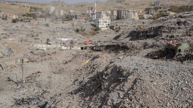 A single standing mosque stands behind construction vehicles demolishing remnants of apartments in the Kurdish city of Sirnak destroyed during a months-long Turkish offensive to reclaim the city from PKK affiliates, July 2016. (Photo: AFP)