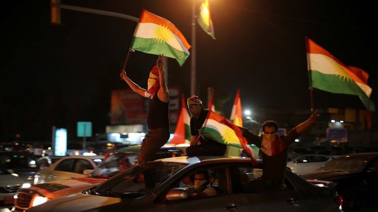 Masked young men celebrates by waving Kurdistan flags in support of Kurdistan Region's referenum on independence from Iraq, Diyarbakir, Turkey, Sept 25, 2017. (Photo: Reuters)