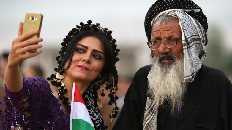 An Iranian Kurdish woman takes a selfie with a man at a rally in Erbil in support of the Kurdistan Region's referendum on independence from Iraq, Sept, 2017. (Photo: AFP)