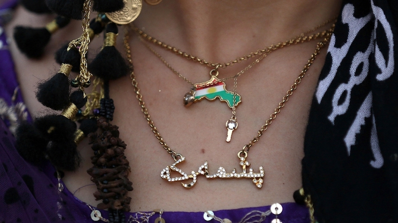 A woman wears a necklace bearing the Kurdish flag on a Kurdistan map as she takes part in support of the Monday referendum on independence from Iraq. (Photo: AFP)