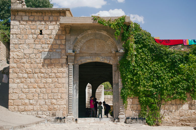 The courtyard is visually dominated by the gate leading to the forecourt of the main temple