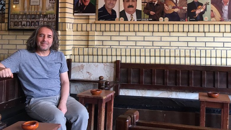 Turkish journalist Fehim Tastekin whose book on Syrian Kurds Turkey banned sits at the historic Machko Teahouse in Erbil, capital of the Kurdistan Region, Aug 27, 2017. (Photo: Tastekin)