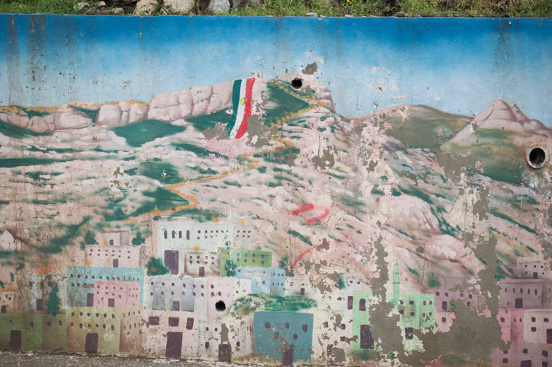 Mural showing the Kurdish flag draped over Kale, as is done on Newroz.
