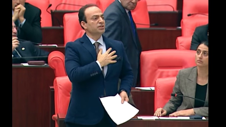 Kurdish lawmaker Osman Baydemir gestures toward his heart when the Turkish Parliament's Speaker asks him where Kurdistan is. He received a banishment for two sessions for naming Kurdistan, Dec. 13, 2017. (Photo: HDP)