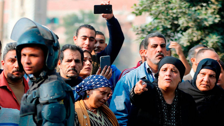 People gather near the site of the attack at a church in Helwan, Cairo on Dec. 29, 2017. (Photo: Reuters)