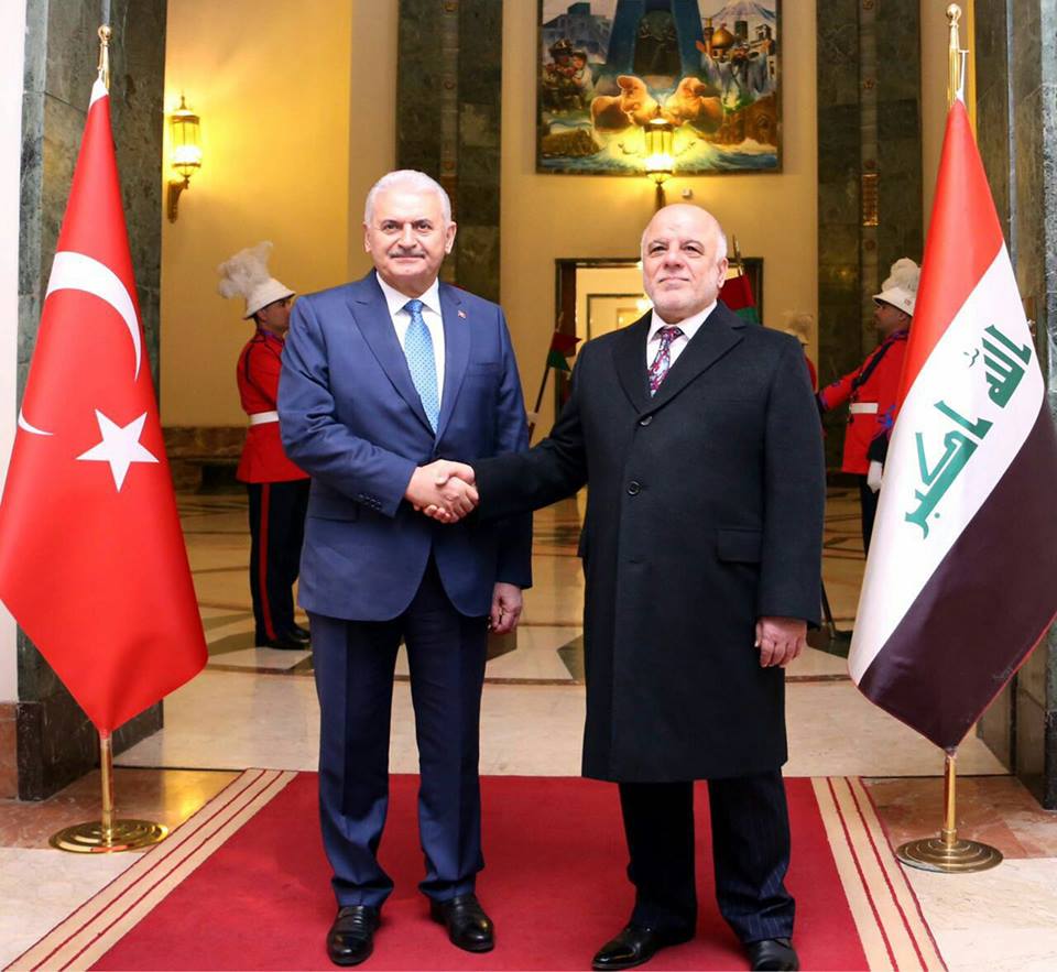 Iraqi Prime Minister Haider al-Abadi welcomes his Turkish counterpart Binali Yildirim at the Council of Minister's office in Baghdad's Green Zone.