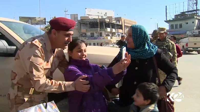 الطفلة قمر تلتقط صورة للذكرى مع العميد بالقوات العراقية يحيى رسول