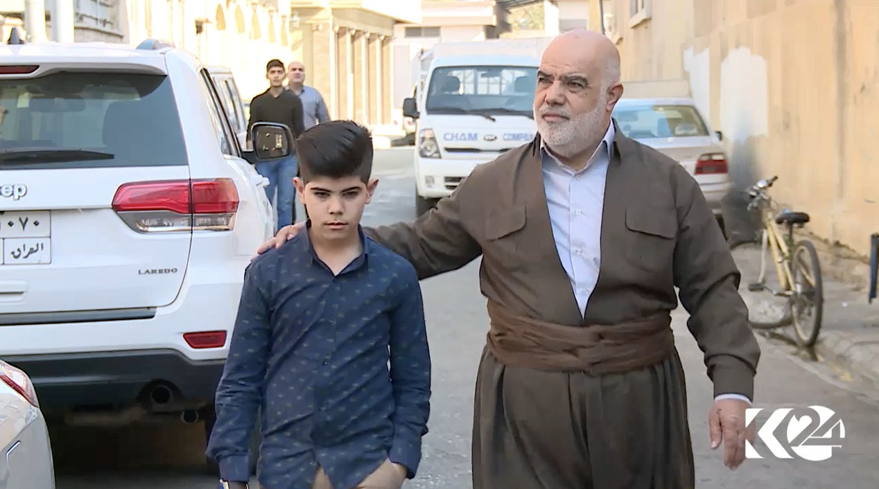 Nuri Ismail walks with his son in Erbil, Kurdistan Region. (Photo: Kurdistan 24)