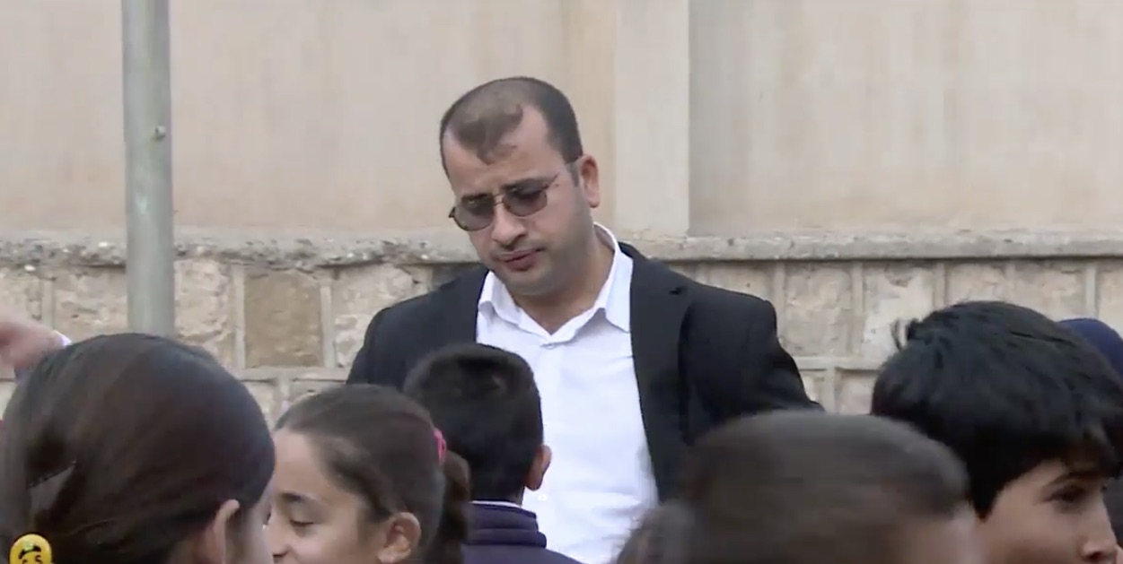 Rizgar Kakarosh, a Kurdish language teacher, speaks with students at the school he works at in his hometown of Taq Taq. (Photo: Kurdistan 24)