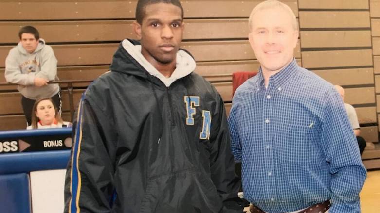 Javion “Jay” Sullivan (L) and Fort Mill High School wrestling coach Chris Brock in 2011. Sullivan, a 2011 graduate of the school and Army specialist, died in Iraq on Monday. (Photo: Social Media)