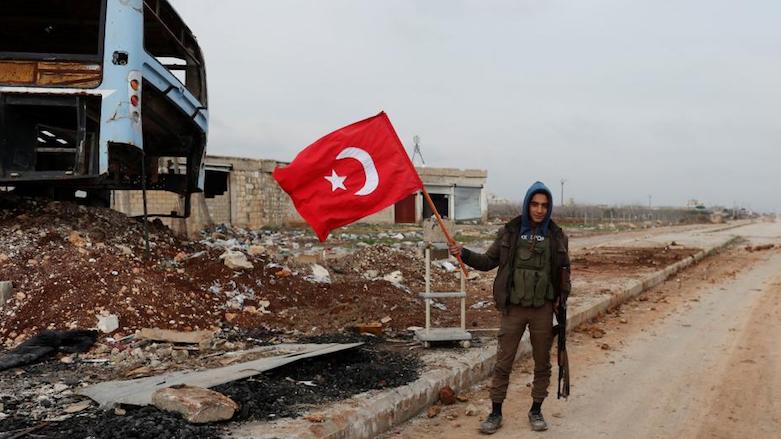 A Turkey-backed Free Syrian Army fighter holds a makeshift Turkish flag as he patrols on the road near Azaz, east of the Kurdish enclave of Afrin, Syria, Jan. 21, 2018. (Photo: Reuters)