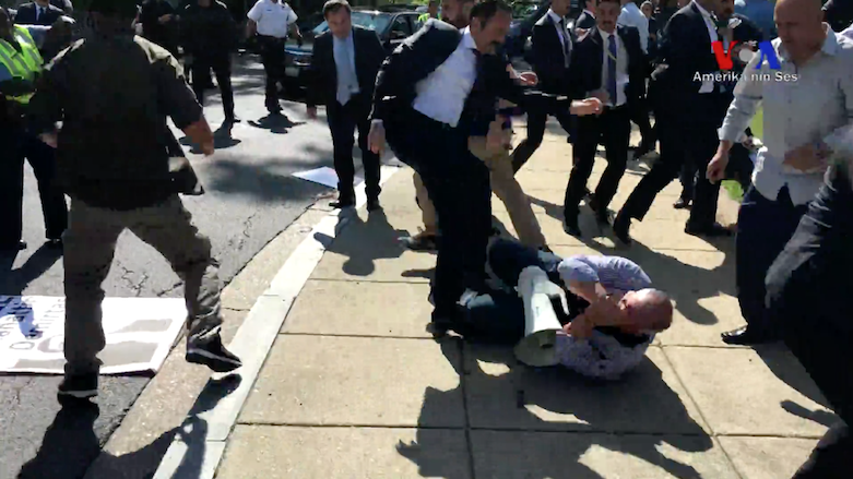 One of Turkish President Recep Tayyip Erdogan's bodyguards kicks a man on the ground during an attack on American-Kurdish protestors on the Massachusetts Avenue, May 16, 2017. (Source: VOA)