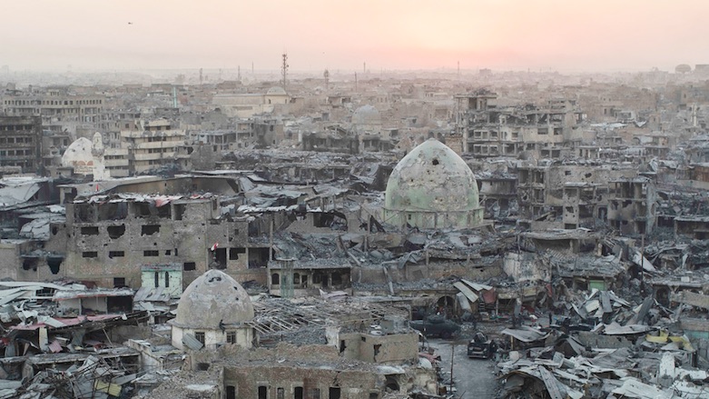 The sun sets behind destroyed buildings in the west side of Mosul, Iraq. (Photo: Associated Press/Felipe Dana)