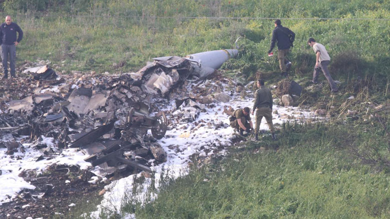 Israeli security forces walk next to the remains of an F-16 Israeli war plane near the village of Harduf, Israel, Feb. 10, 2018. (Photo: Reuters/Herzie Shapira)