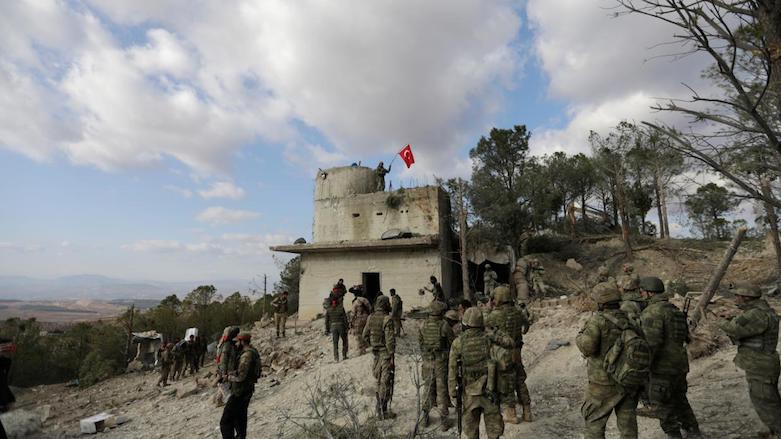 Turkish forces wave a flag on Mount Barsaya, northeast of Afrin, Syria, Jan. 28, 2018. (Photo: Reuters/Khalil Ashawi)