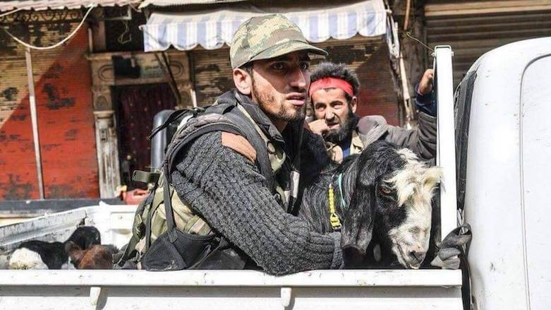 Turkish-led Syrian Arab fighters ride the back of a pick-up with looted goats after seizing control of the town of Afrin in Syrian Kurdistan, March 18, 2018. (Photo: AFP)