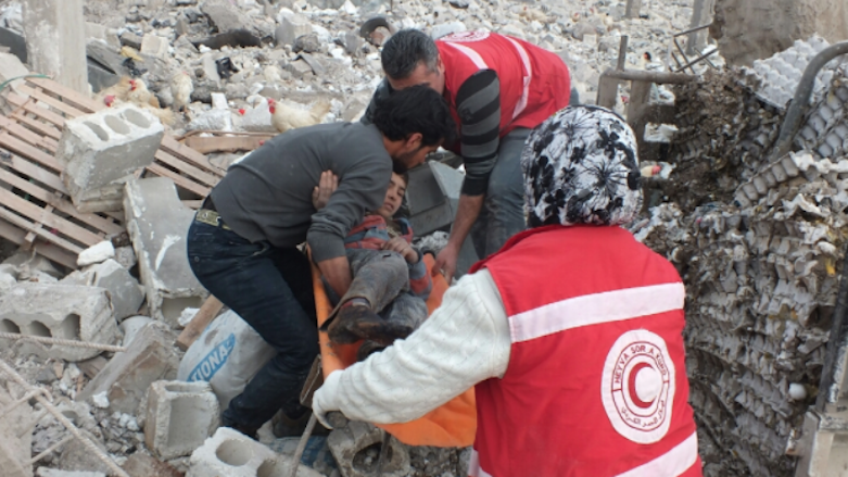 Kurdish Red Crescent workers retrieve killed and wounded civilians from under rubble of a poultry farm hit by Turkish airstrikes in Afrin countryside, January 2018. (Photo: Kurdistan 24)