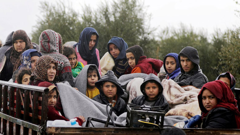 People sit in a truck with their belongings, northeast of Afrin, on Thursday. (Photo: Khalil Ashawi/Reuters)