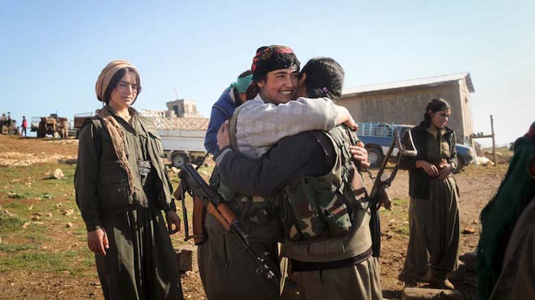 A Kurdistan Workers' Party (PKK) fighter hugs her comrades as she leaves to go to another base in Shingal, Kurdistan Region, March 13, 2015. (Photo: Reuters)