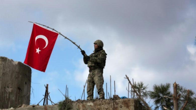 A Turkish soldier waves a flag on Mount Barsaya, northeast of Afrin, Syrian Kurdistan, Jan. 28, 2018. (Photo: Reuters)