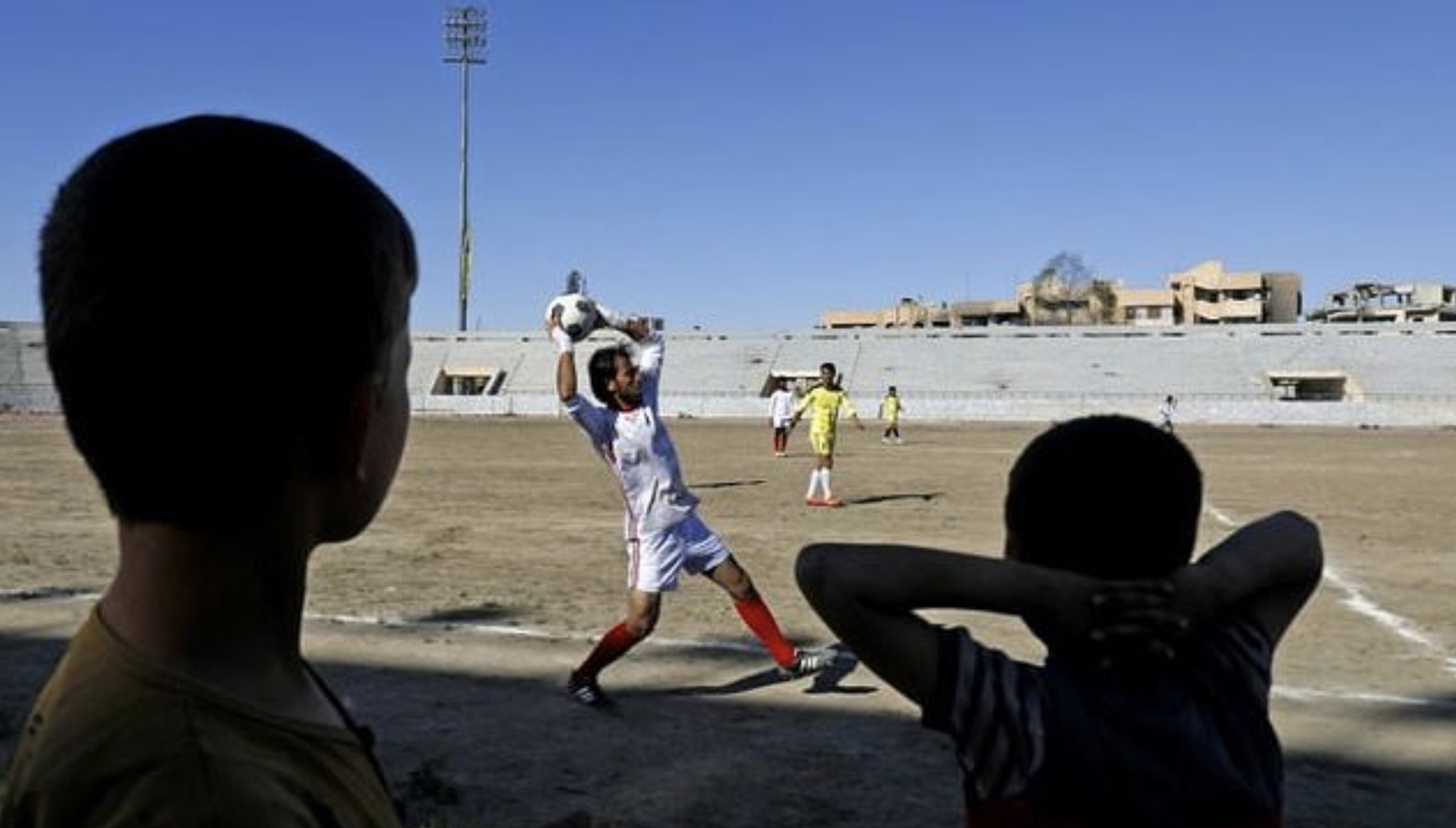 Fans watch a football match on April 16, 2018, between local teams at a stadium in Raqqa that the Islamic State once used as a prison. (Photo: AFP)