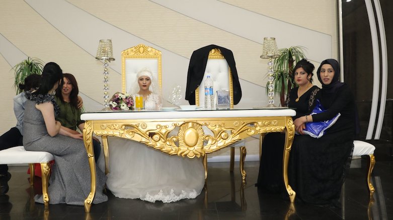Jailed groom Rohat Akboga's jacket seen on the chair next to his bride Sara Basak during their wedding ceremony in his absence in the Kurdish city of Diyarbakir. Akboga was sent to jail a day earlier for criticism of Turkish government forces and President Erdogan. April 6, 2018. (Photo: Mezopotamya)