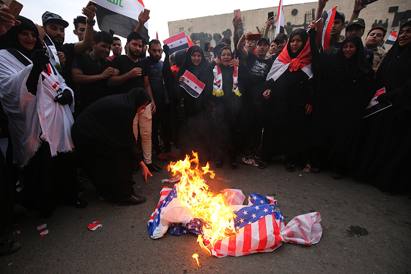 Iraqi protestors burn a US flag during a protest in Baghdad on Sunday opposing the joint Western airstrikes against Syria's regime. (Photo: AFP)