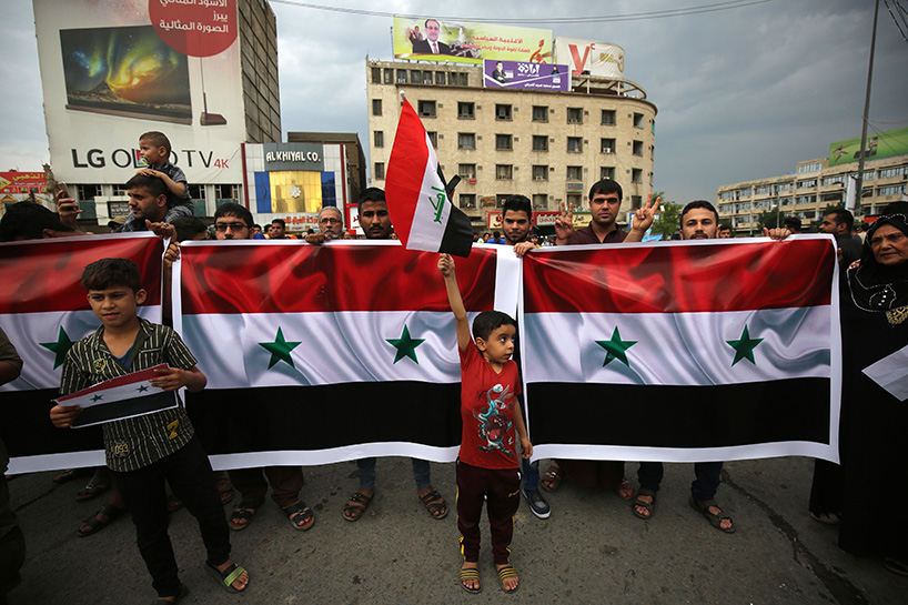 Iraqi protestors burn a US flag during a protest in Baghdad on Sunday opposing the joint Western airstrikes against Syria's regime. (Photo: AFP)