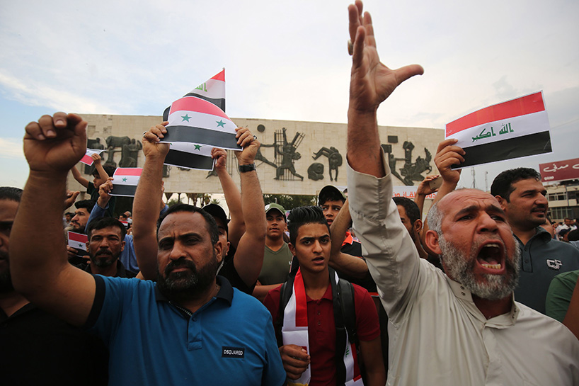 Iraqi protestors burn a US flag during a protest in Baghdad on Sunday opposing the joint Western airstrikes against Syria's regime. (Photo: AFP)